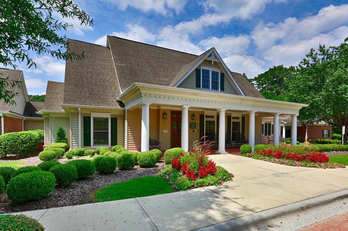 A charming suburban house with a landscaped front yard and driveway.