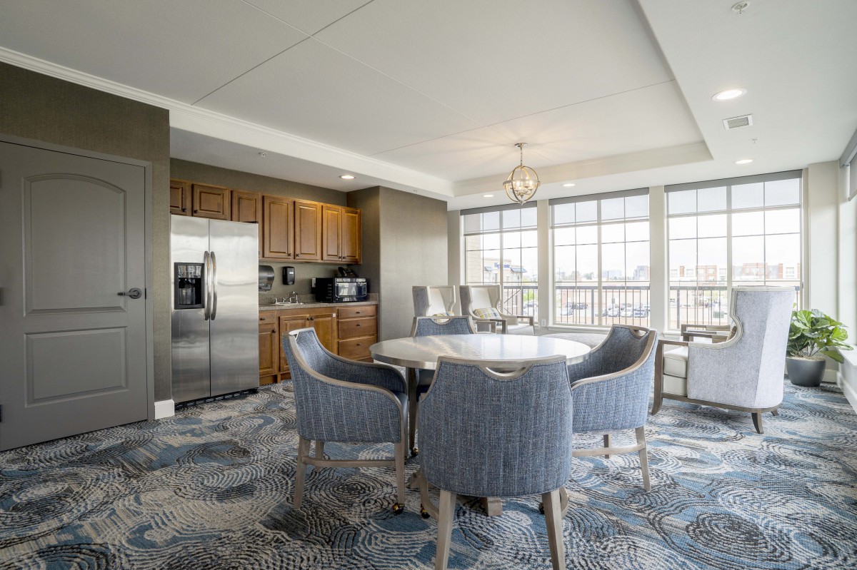 A modern kitchen and dining area with ample natural light and stylish furnishings.
