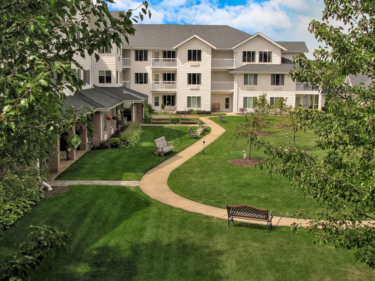 A residential building with a landscaped garden and pathway.