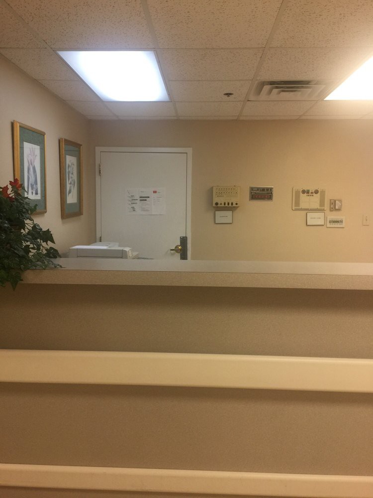 A quiet reception area with a desk and wall decorations.