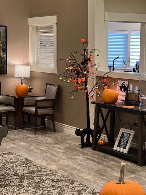 A cozy indoor setting decorated with pumpkins and autumn-themed decor, perfect for the Halloween season.