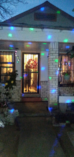 A beautifully decorated doorway illuminated with colorful lights during the holiday season.