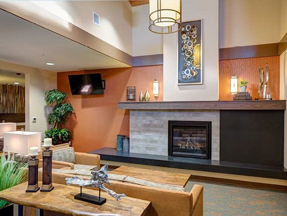 A modern living room featuring a fireplace, stylish wall art, and comfortable seating.