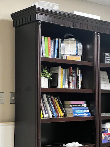 A neatly organized bookshelf showcasing a collection of books and decorative items.