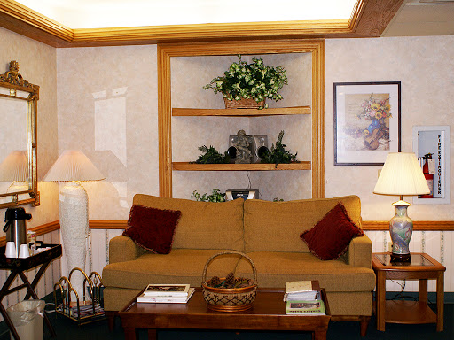 A cozy living room setup featuring a comfortable sofa, decorative shelves, and warm lighting.