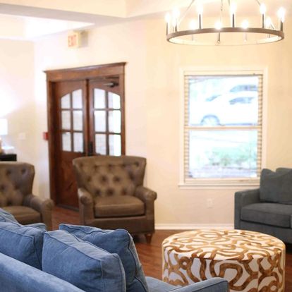 A cozy living room featuring comfortable blue chairs, stylish decor, and a welcoming atmosphere.