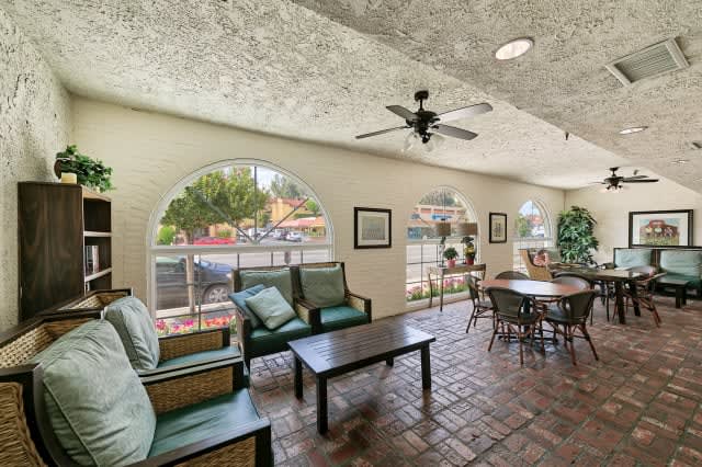 A cozy lounge area with comfortable seating and natural light from large windows.