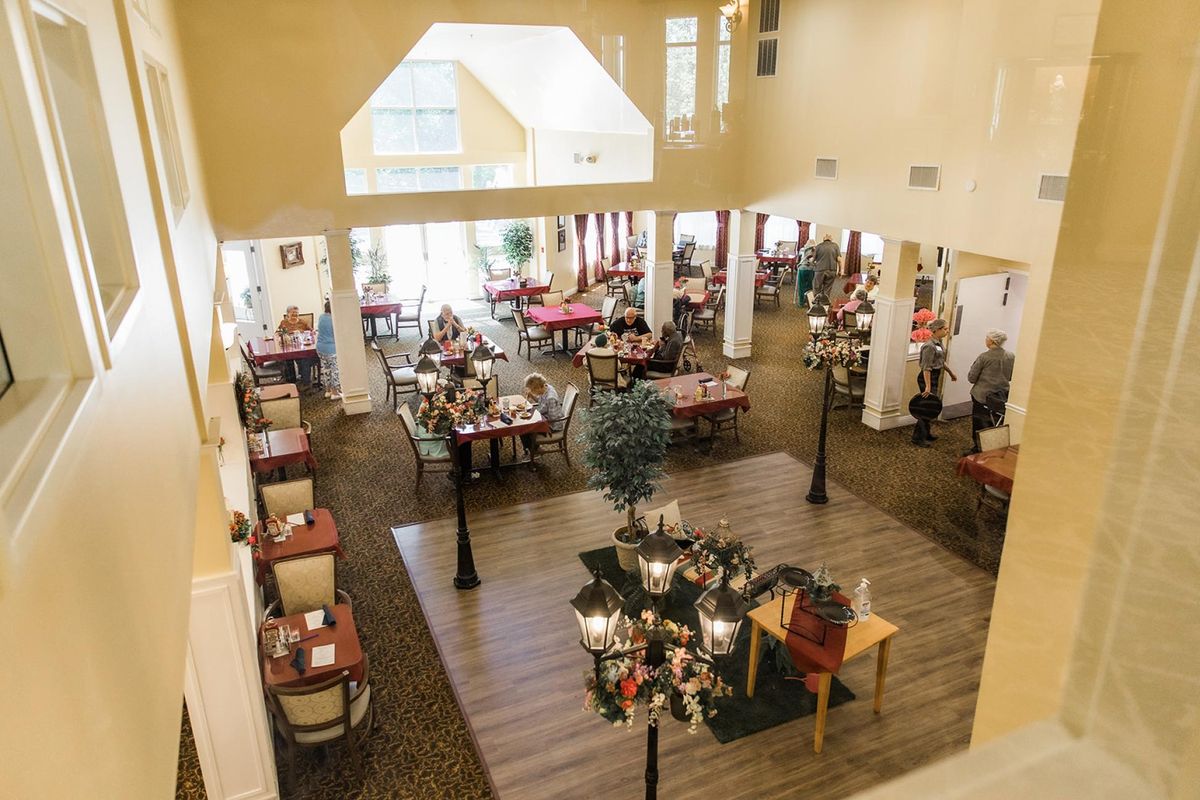 A spacious dining area with tables and people enjoying their meals.