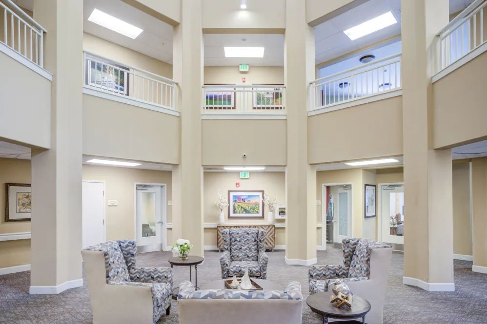 A spacious and well-lit lobby featuring comfortable seating and elegant decor.