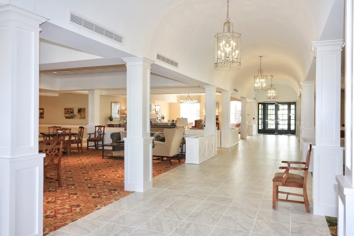 A spacious and elegantly decorated lobby with seating areas and chandeliers.