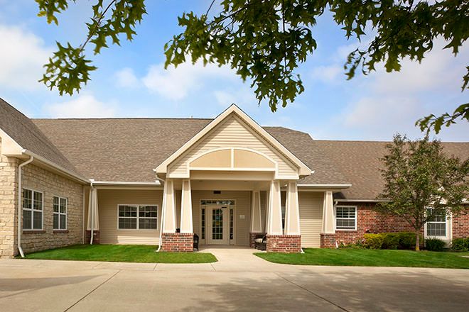 A well-maintained residential building with a neatly landscaped entrance.