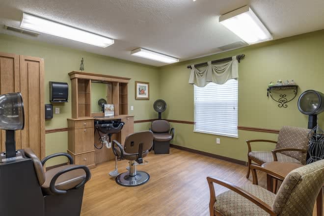 An interior view of a hair salon with chairs and hair styling equipment.