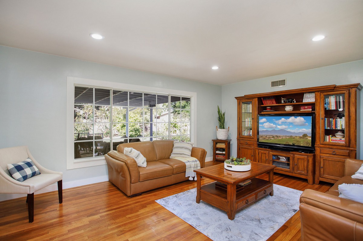 Cozy living room with a sofa, coffee table, and large window.