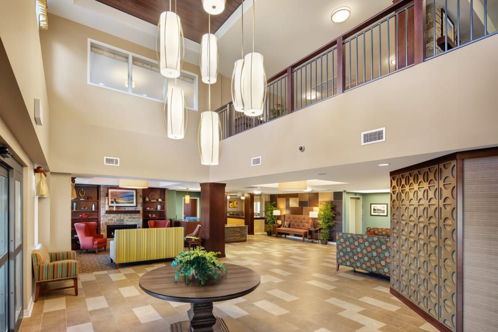 A modern hotel lobby with elegant chandeliers and comfortable seating areas.