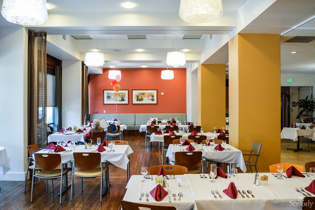 An elegant restaurant dining area with neatly arranged tables and chairs.
