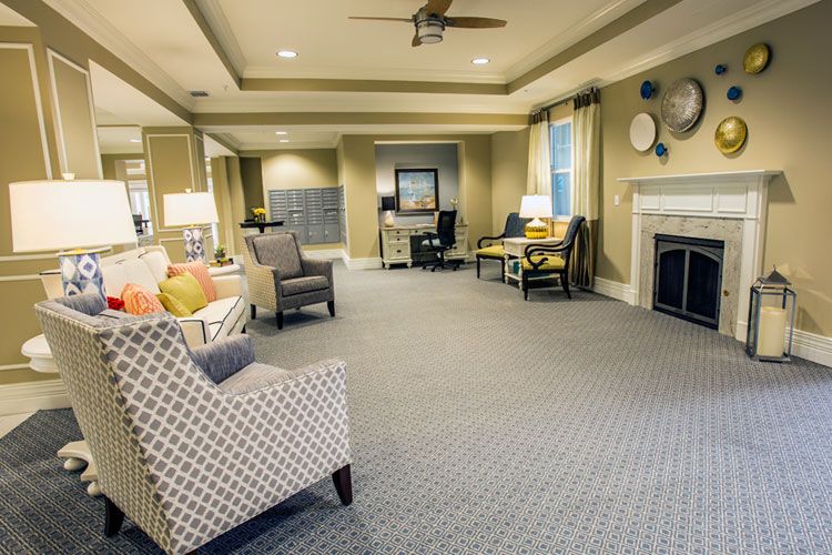 A spacious and elegantly designed living room featuring modern furniture and a cozy fireplace.
