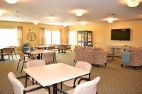 A bright and spacious lounge area with tables and chairs.