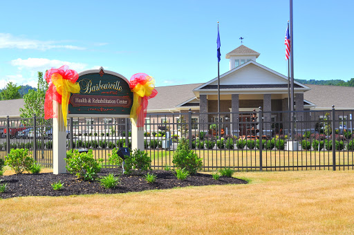 A welcoming entrance with a decorative sign and well-maintained landscaping.