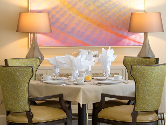 Elegant dining table setup with stylish decor and warm lighting.