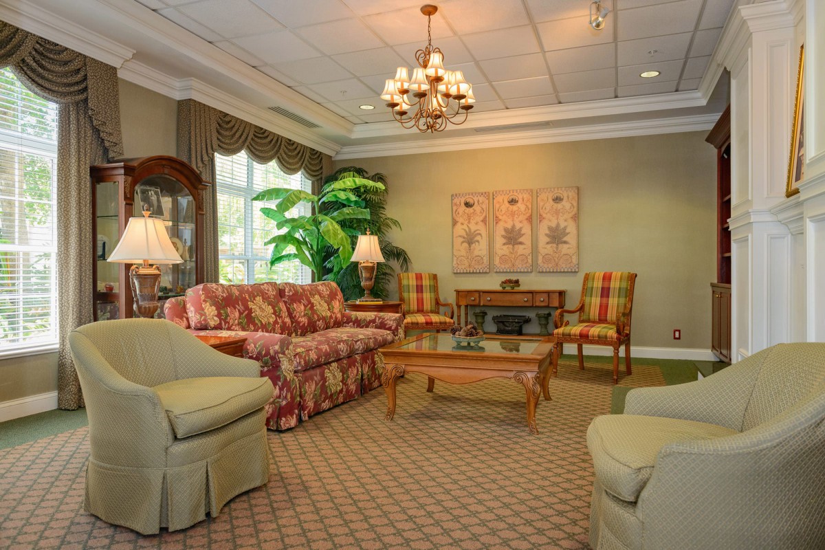 A cozy traditional living room with elegant furniture and warm lighting.