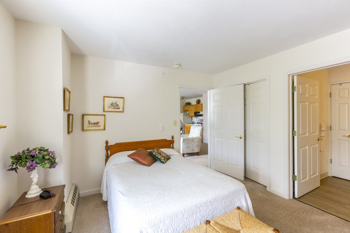 A cozy and minimalist bedroom with a neatly made bed and simple decor.