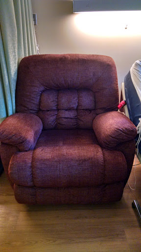 A plush purple recliner chair, perfect for relaxing in any living space.