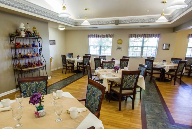 An inviting dining room with elegantly set tables and comfortable chairs.