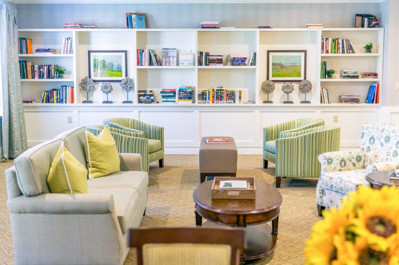 A cozy living room with comfortable seating and bookshelves.