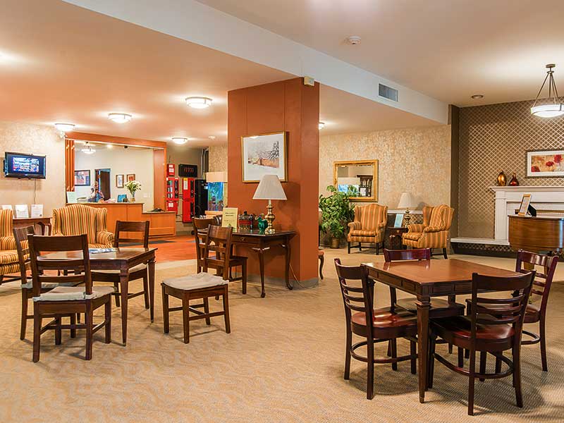 A cozy hotel lobby with a seating area and reception desk.