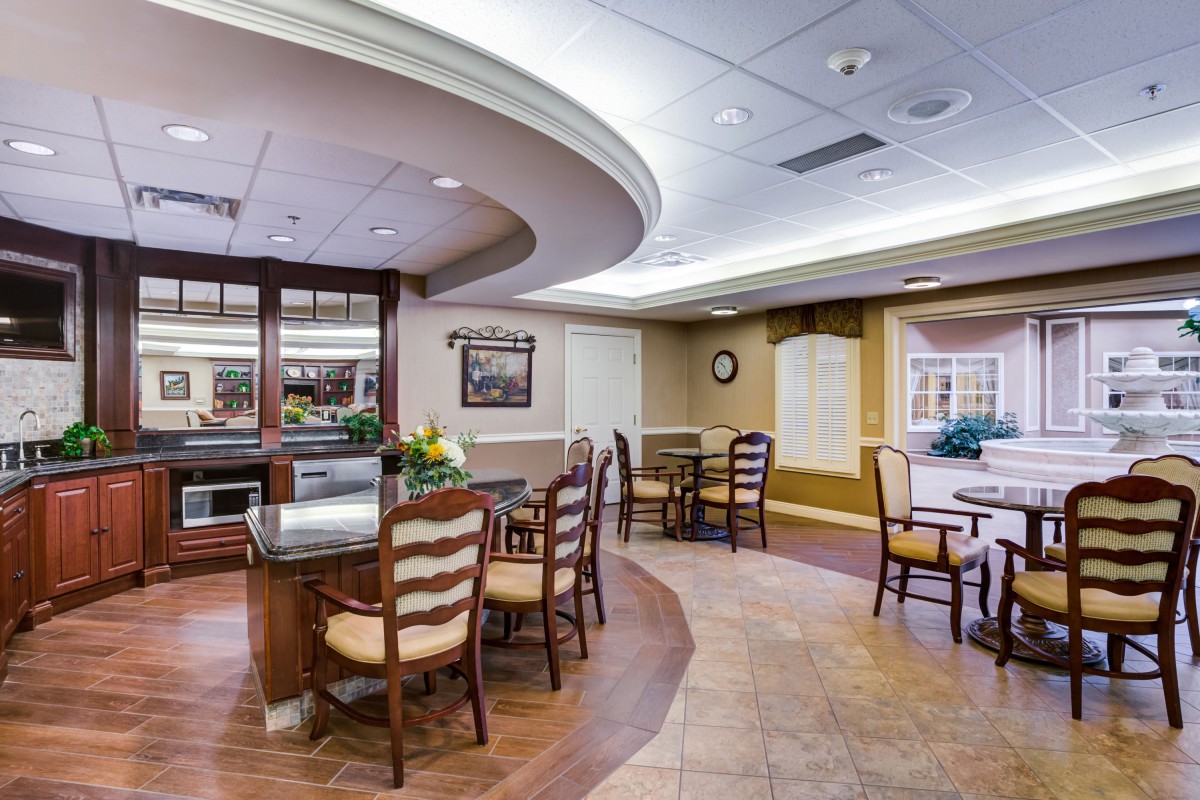 A well-lit dining area with tables and chairs arranged neatly.