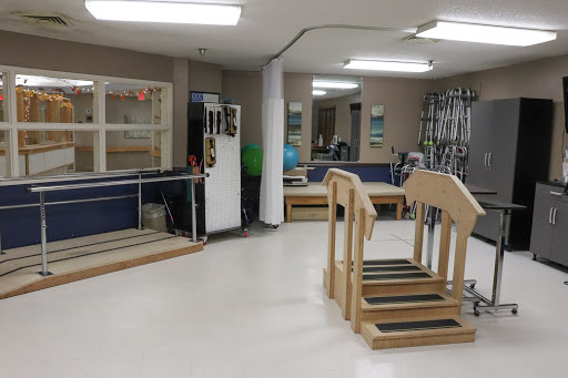A physical therapy room equipped with various rehabilitation tools and walking aids.
