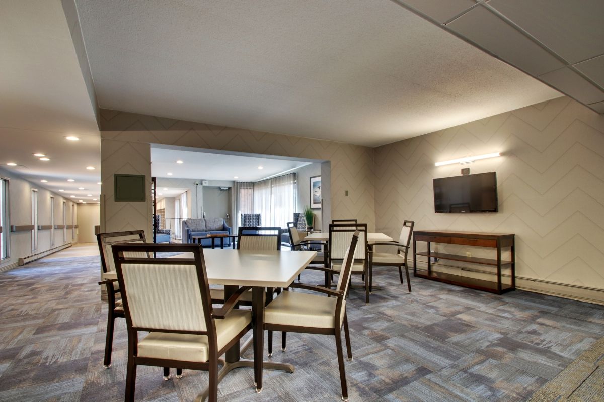A modern conference room with a large table and chairs arranged for meetings.