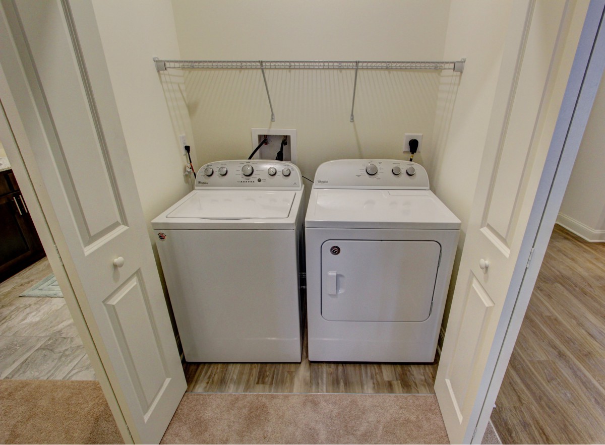 A compact laundry area with a washing machine and dryer side by side.