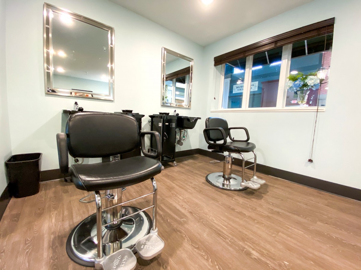 A well-equipped hair salon with chairs and mirrors ready for customers.