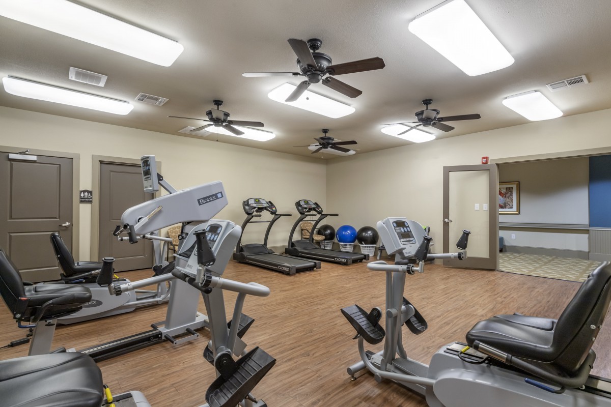 A fitness center equipped with treadmills and stationary bikes.