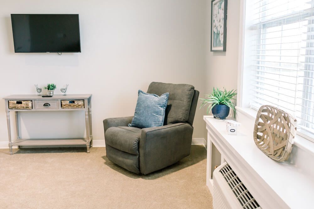 A cozy living room with a comfortable armchair and decorative elements.