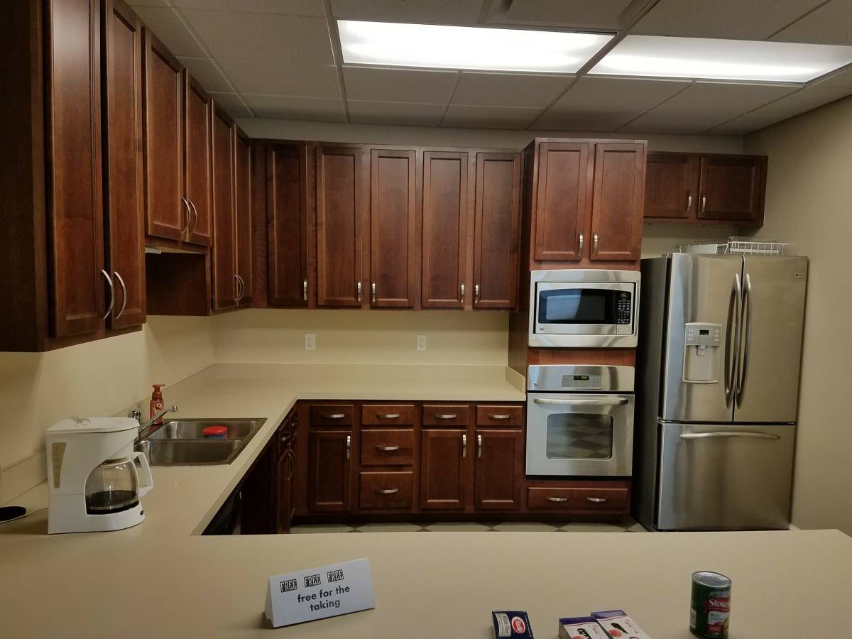 A modern kitchen with wooden cabinets and stainless steel appliances.