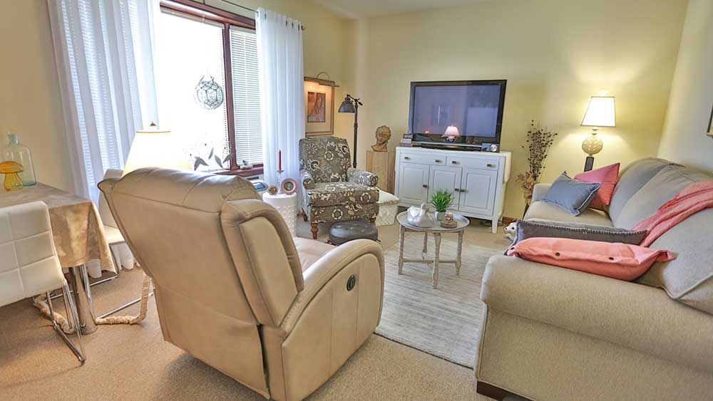 A cozy living room with comfortable seating, a television, and decorative elements.