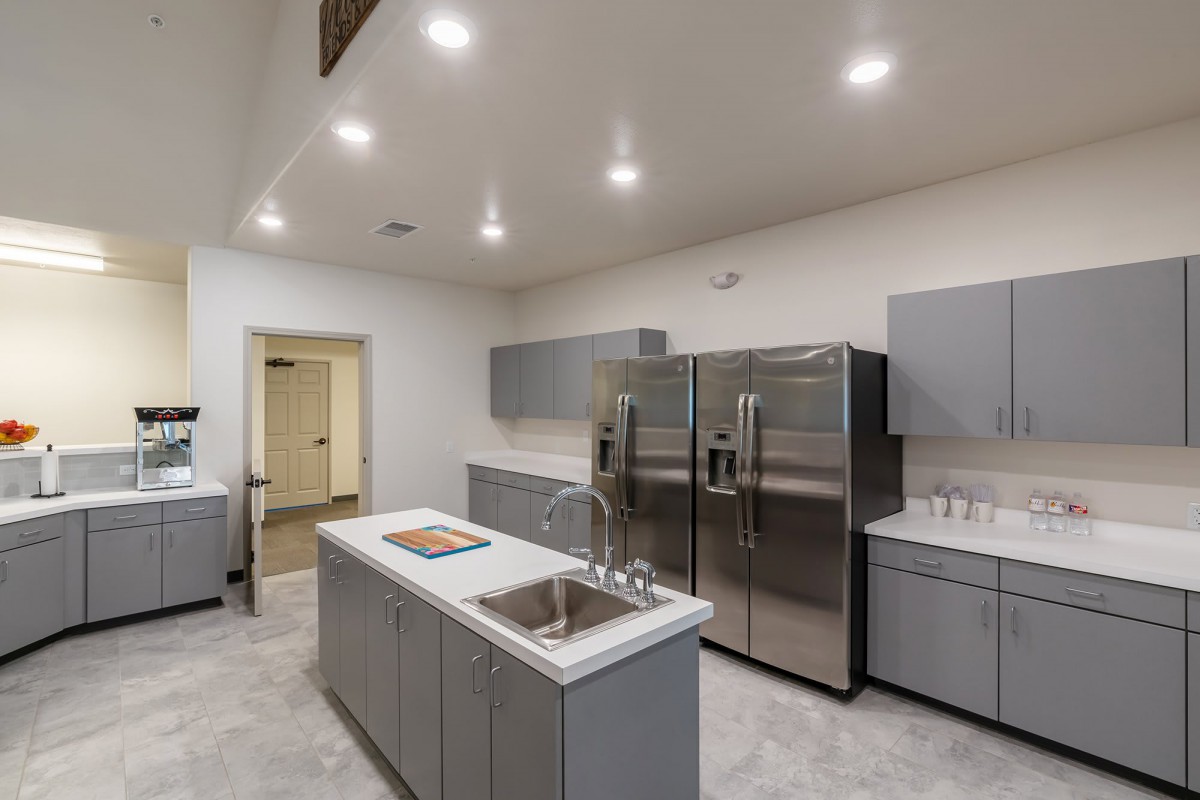A modern kitchen with stainless steel appliances and minimalist design.