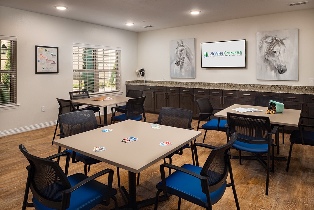 A modern conference room with neatly arranged tables and chairs, ready for a meeting.