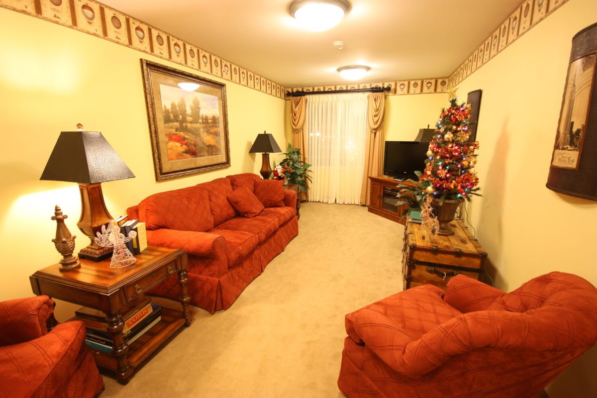 A cozy living room with orange sofas, decorative elements, and a television.