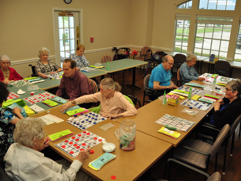 A group of senior citizens playing bingo at a community center.