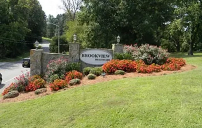 Entrance sign with vibrant landscaping at a residential area.