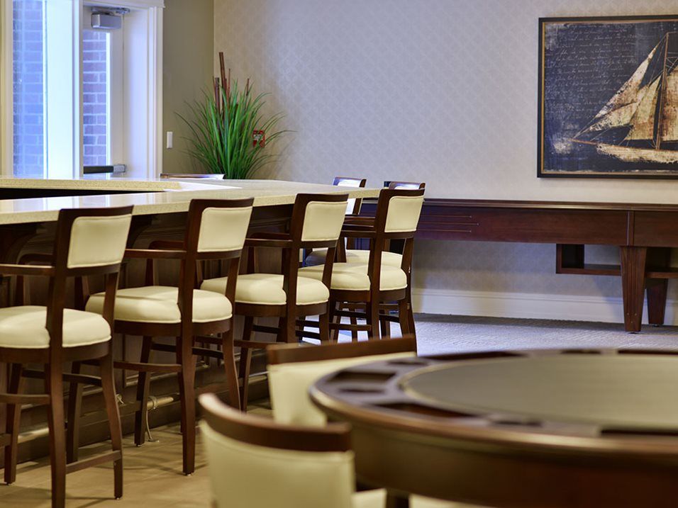 A modern bar interior with high chairs and tables.