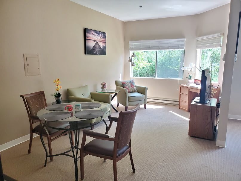 A bright, cozy living room with a dining area and comfortable seating.