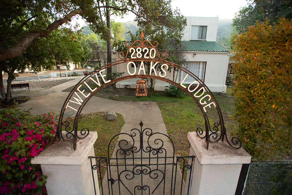 Entrance gate to Twelve Oaks Lodge with an archway sign.