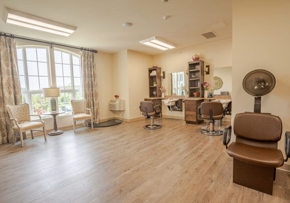 A spacious salon interior with styling chairs, mirrors, and natural lighting.