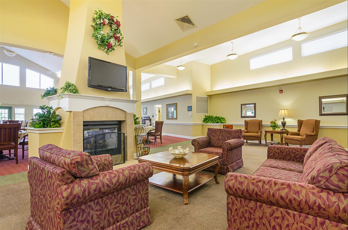 A cozy living room with a fireplace, television, and comfortable furniture.
