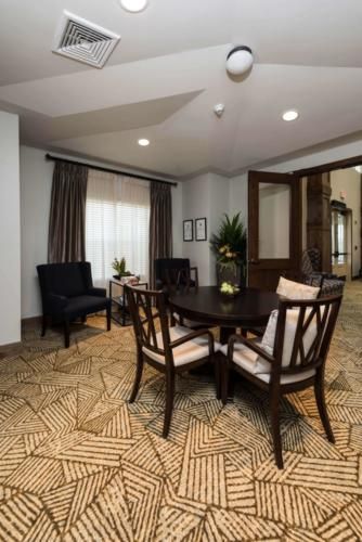 A cozy living room area with a round table and chairs, showcasing elegant decor.