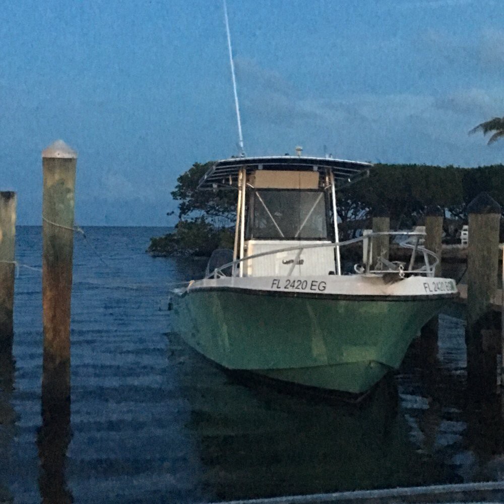 A boat docked on calm waters during the evening.